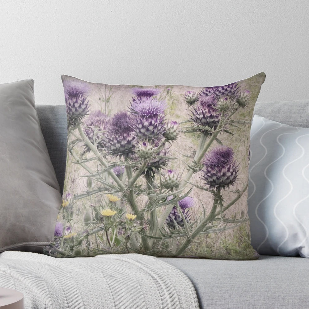 Close-up of a purple thistle and yellow daisy floral pattern on a decorative throw pillow