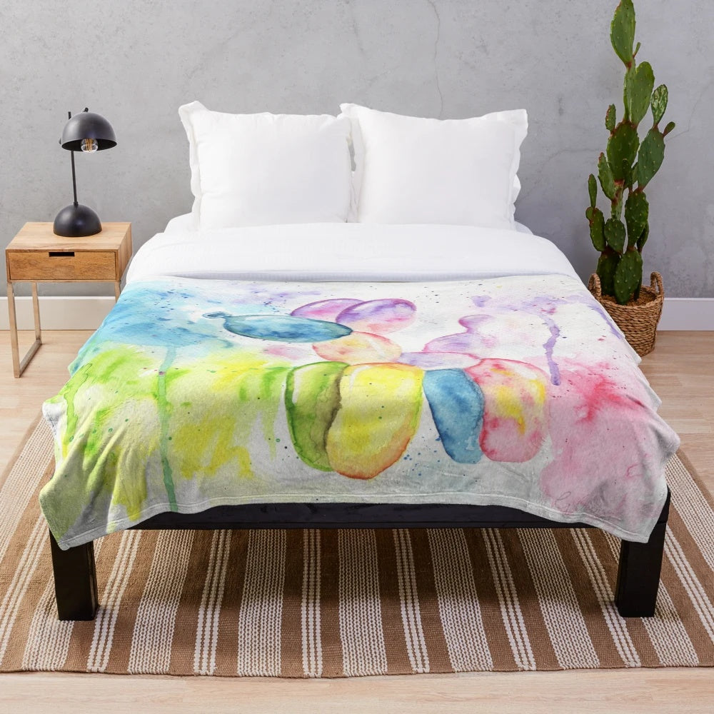 Colorful plush blanket featuring a whimsical rainbow balloon dog design