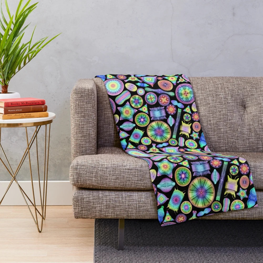 Vibrant rainbow diatoms pattern on a soft, plush blanket inspired by the scientific illustrations of Ernst Haeckel