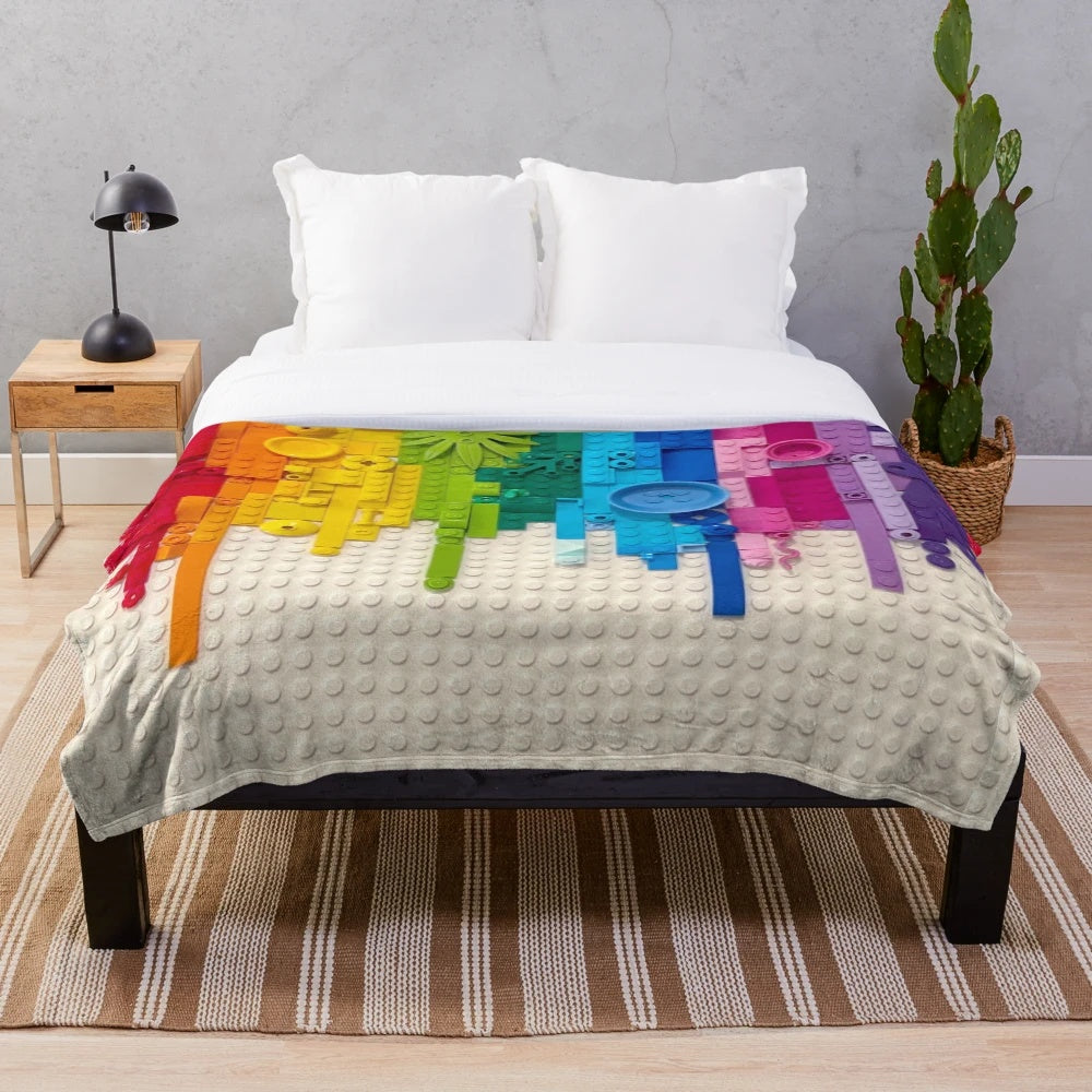 Colorful rainbow drip plush blanket with lego-inspired xray skeleton design