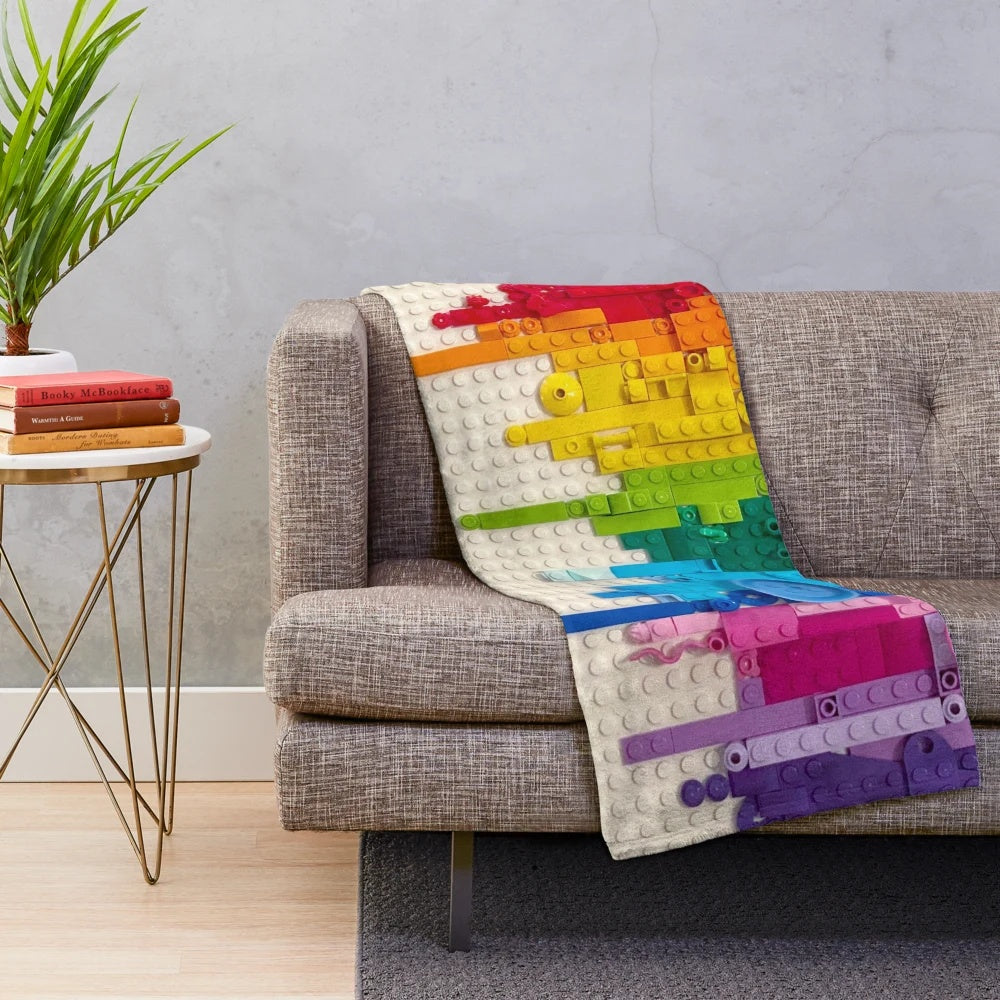 Colorful rainbow drip plush blanket with lego-inspired xray skeleton design