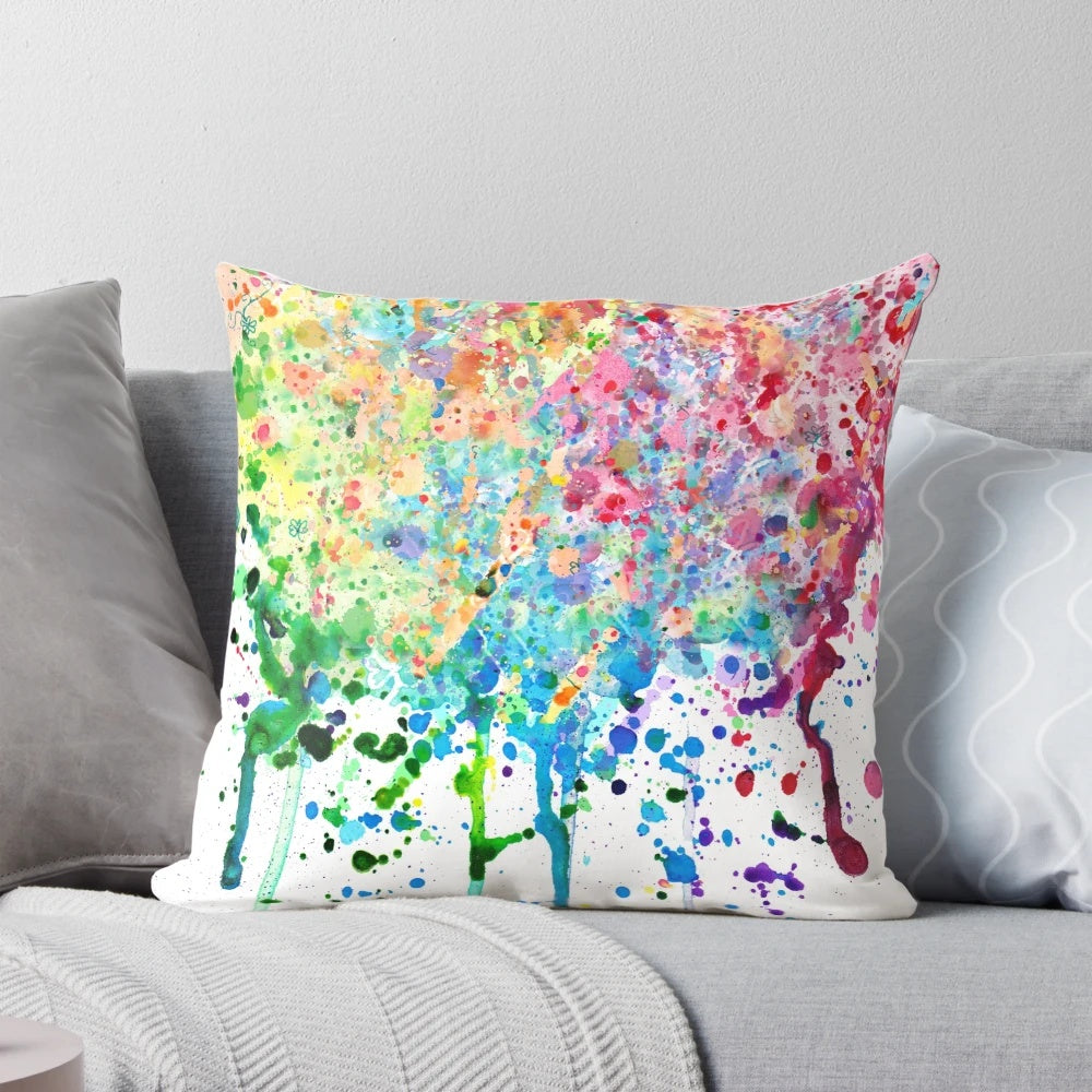 Colorful rainbow paint splatter and drip design on a decorative throw pillow