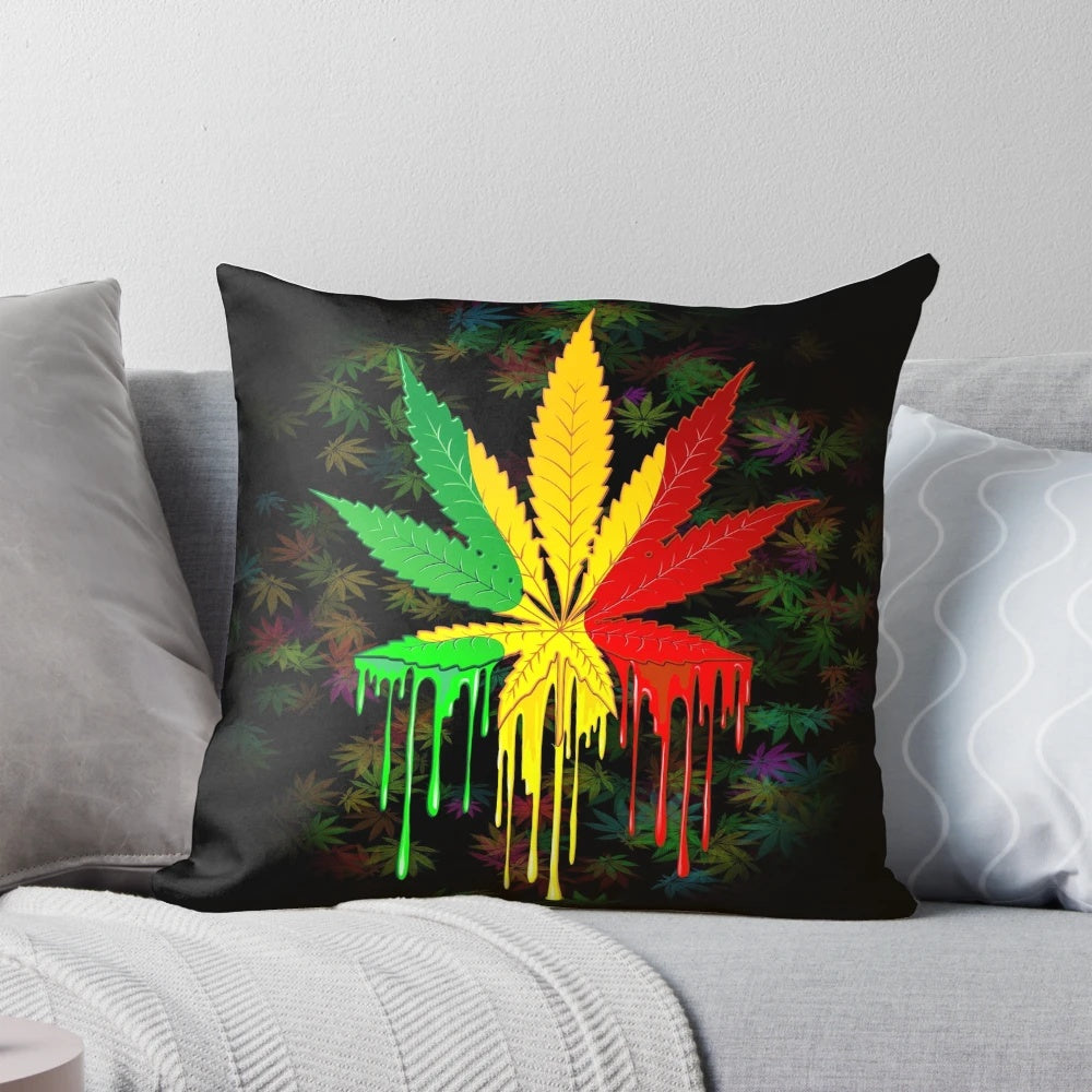 Colorful rasta-inspired leaf pillow with dripping paint design