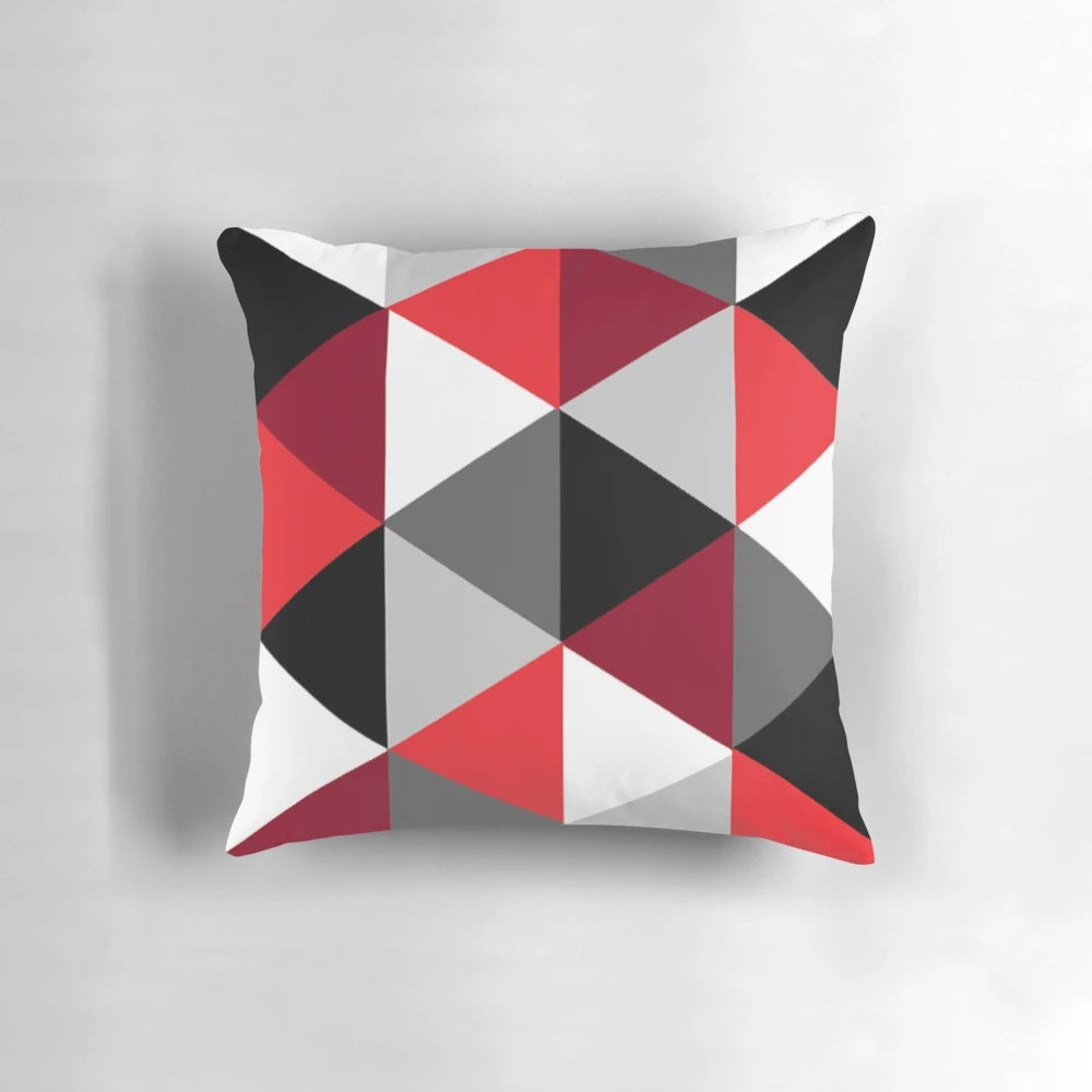 Stylish geometric pattern pillow in shades of red, black, white and grey