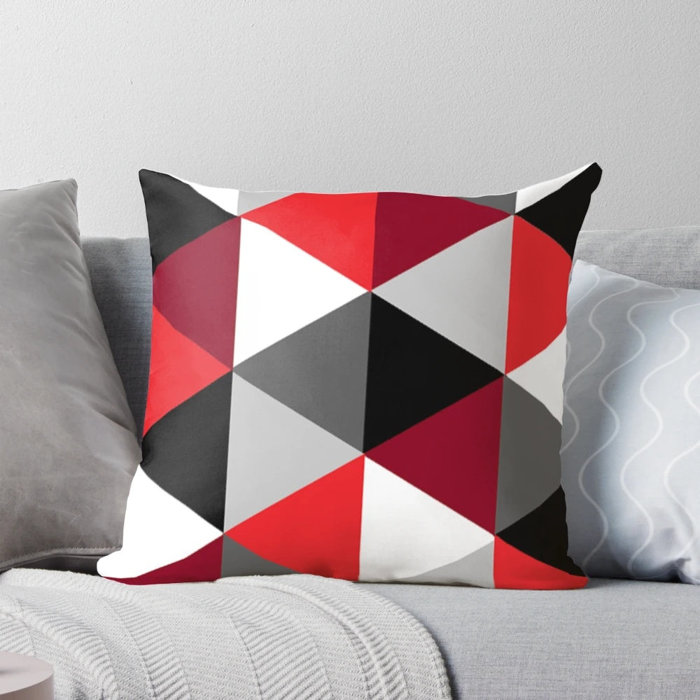 Stylish geometric pattern pillow in shades of red, black, white and grey