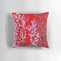 Red and pink cherry blossom floral pattern on a decorative throw pillow