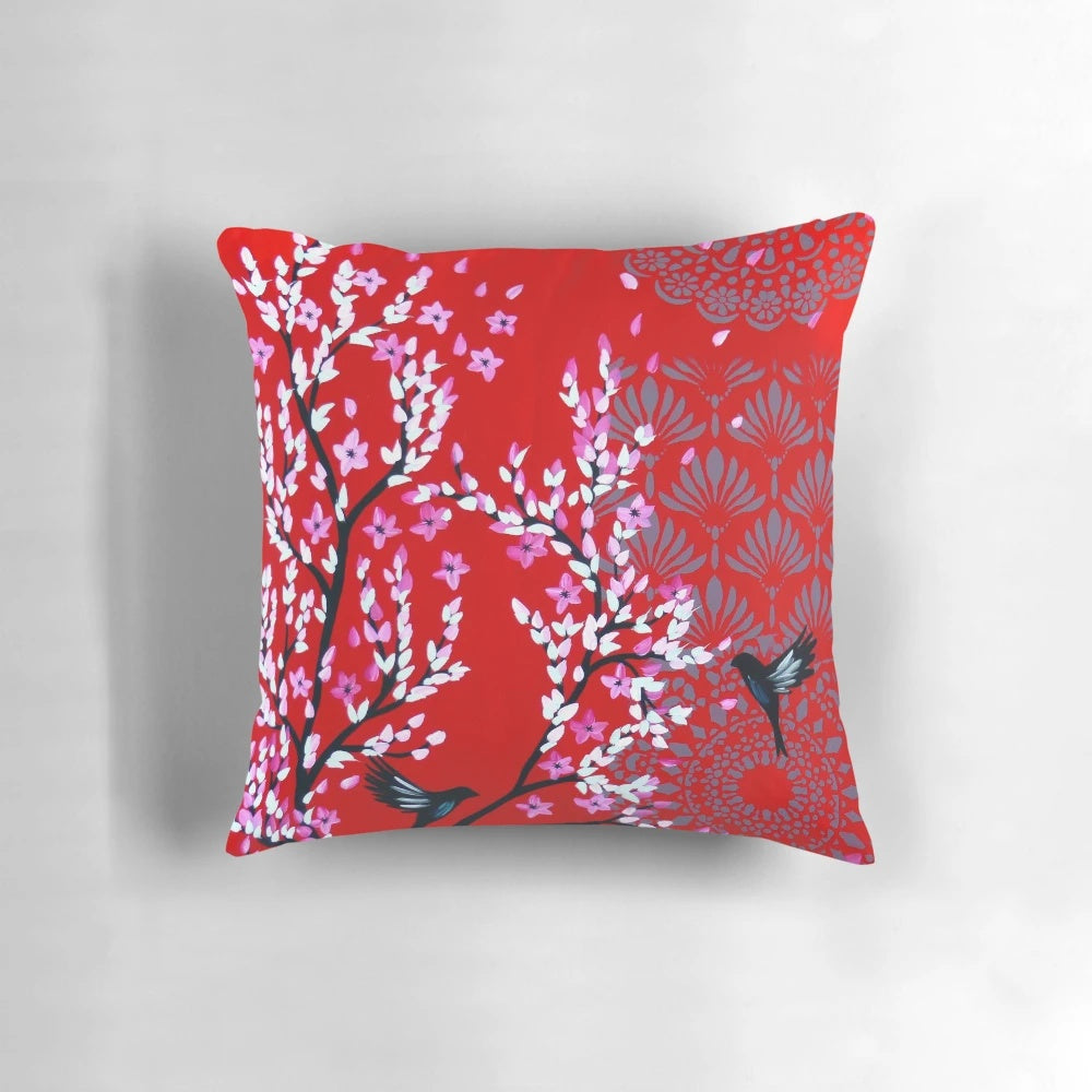 Red and pink cherry blossom floral pattern on a decorative throw pillow