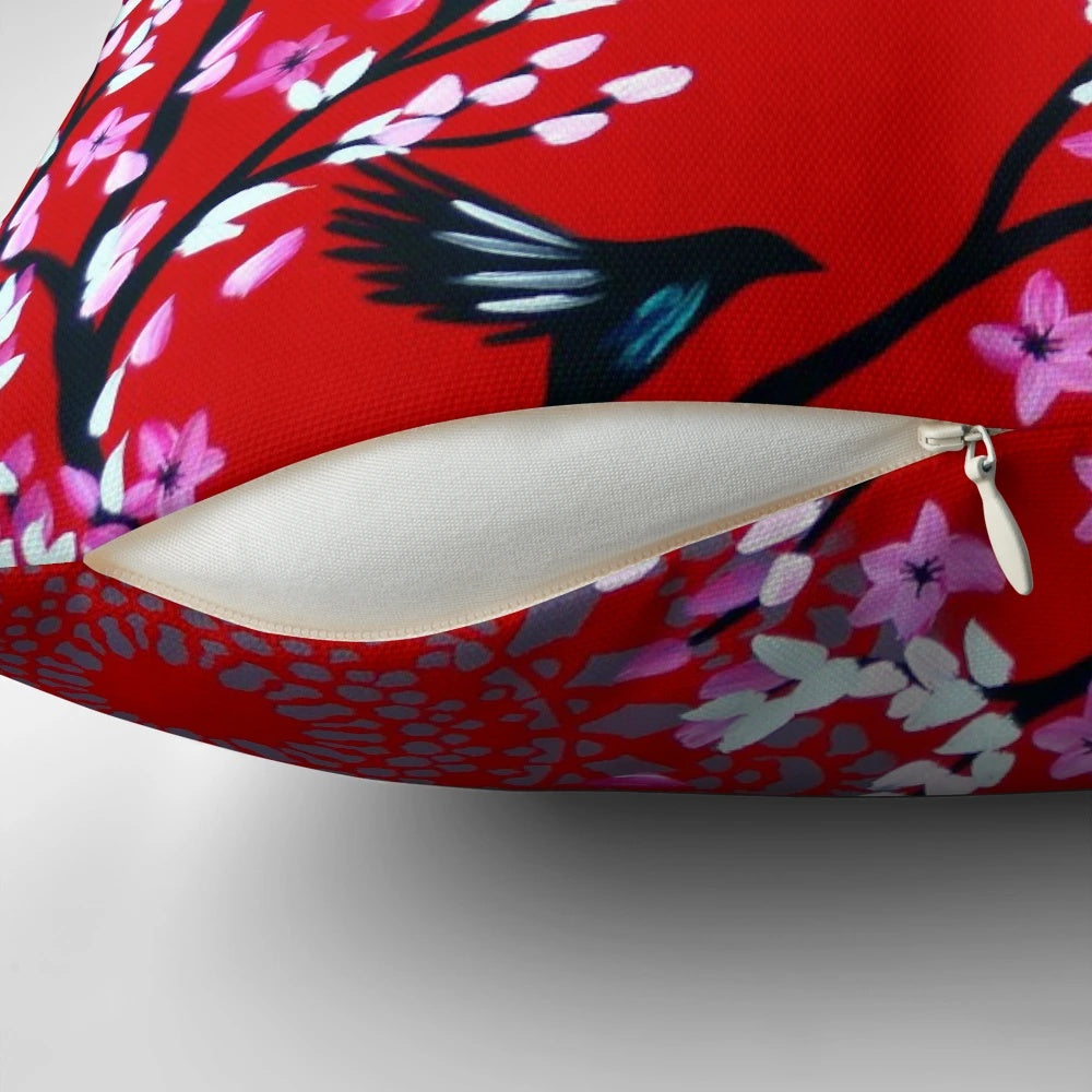 Red and pink cherry blossom floral pattern on a decorative throw pillow