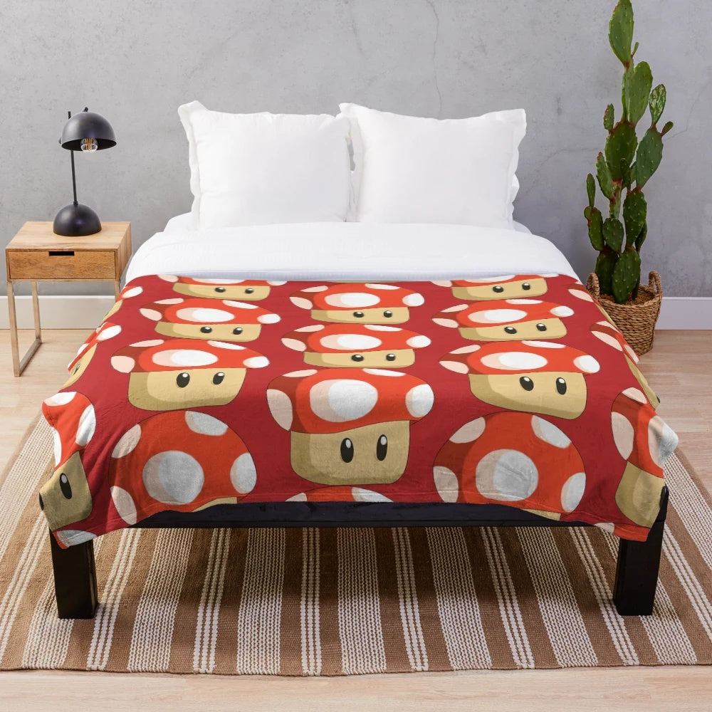 Red mushroom plush blanket featuring a retro gaming inspired design