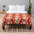 Red mushroom plush blanket featuring a retro gaming inspired design