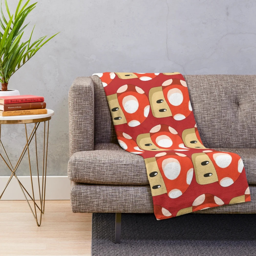 Red mushroom plush blanket featuring a retro gaming inspired design