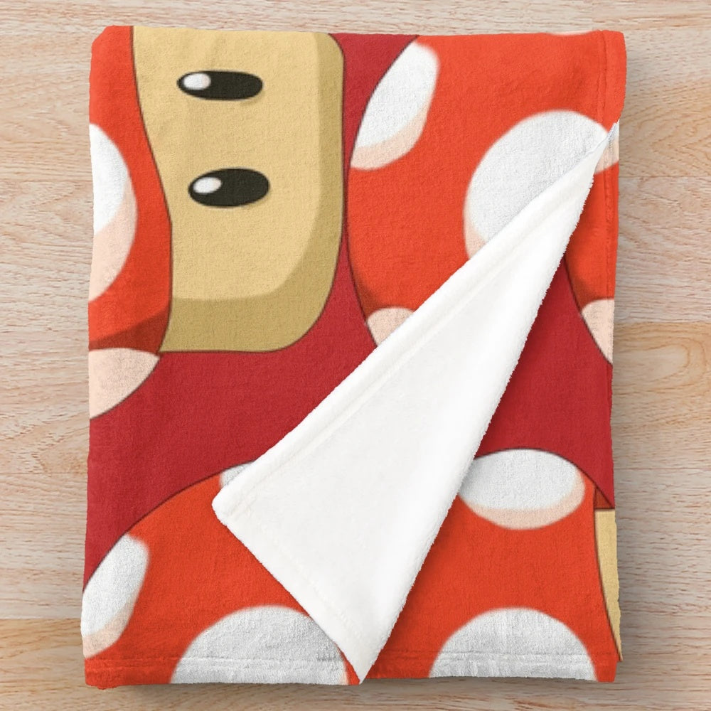 Red mushroom plush blanket featuring a retro gaming inspired design