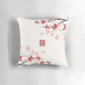 A decorative pillow featuring vibrant red cherry blossoms and oriental design elements.