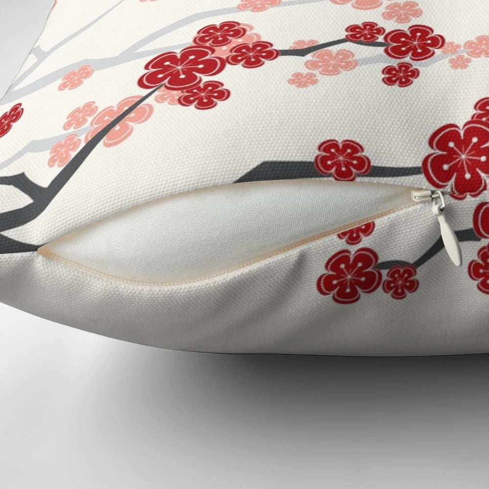 A decorative pillow featuring vibrant red cherry blossoms and oriental design elements.