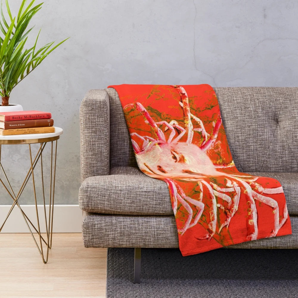 Closeup of a soft, plush blanket featuring a detailed red scorpion design in an abstract, mythological style