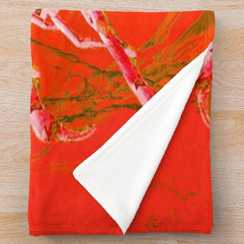 Closeup of a soft, plush blanket featuring a detailed red scorpion design in an abstract, mythological style