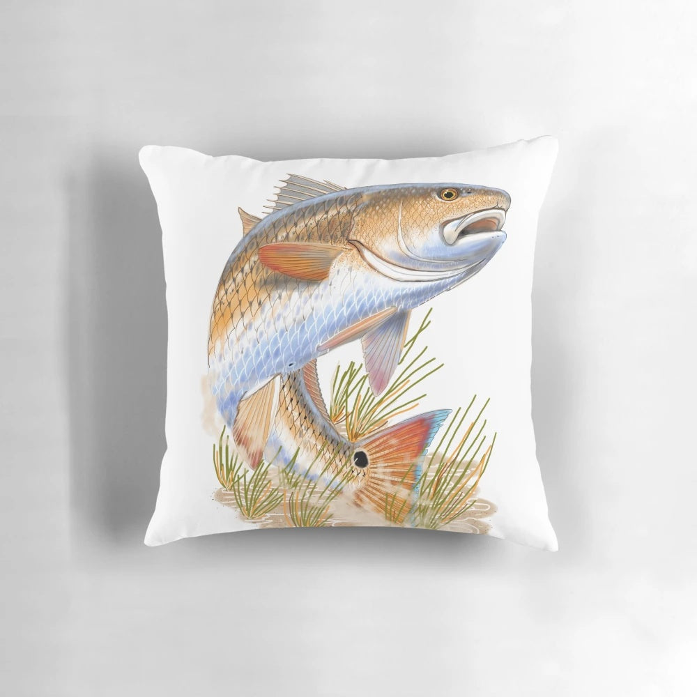 Pillow featuring a vibrant illustration of a redfish swimming in a grassy coastal scene, designed by marine artist Carey Chen.