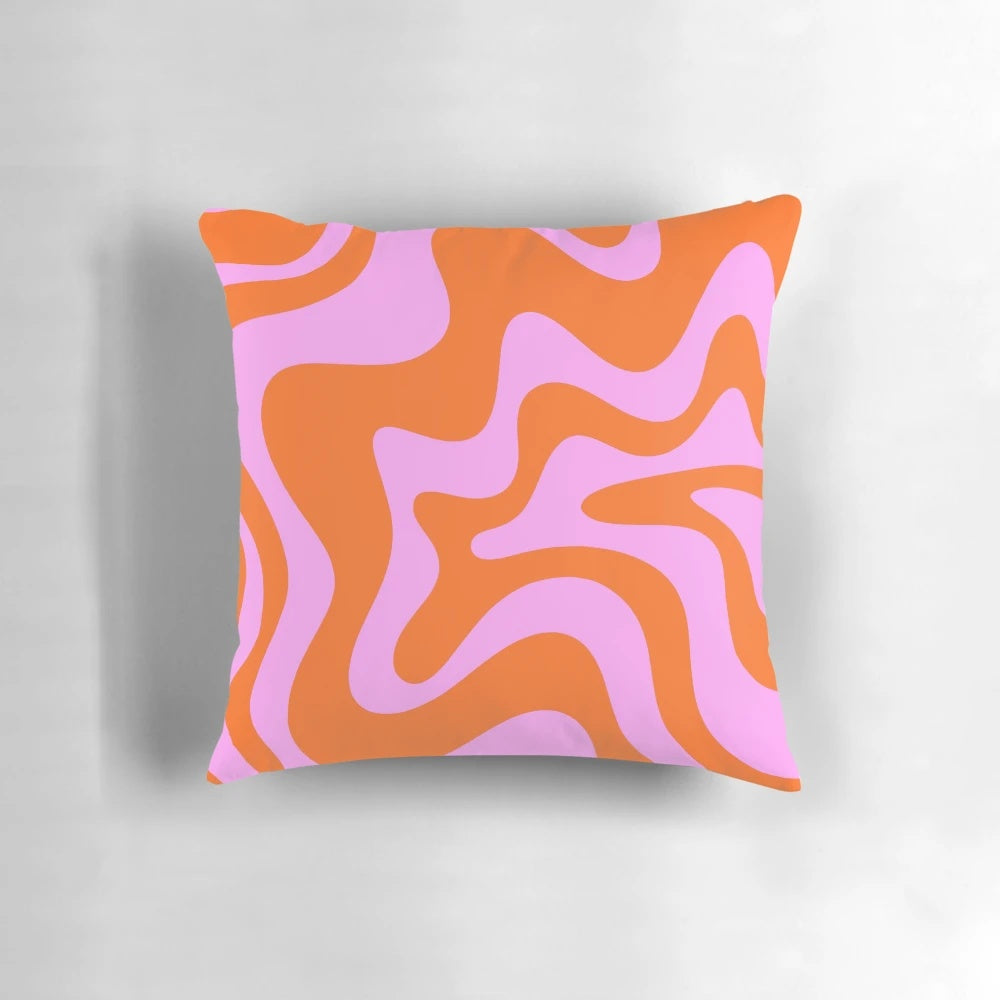 Retro-inspired abstract pattern pillow in hot pink and red-orange with a vibrant swirling design.