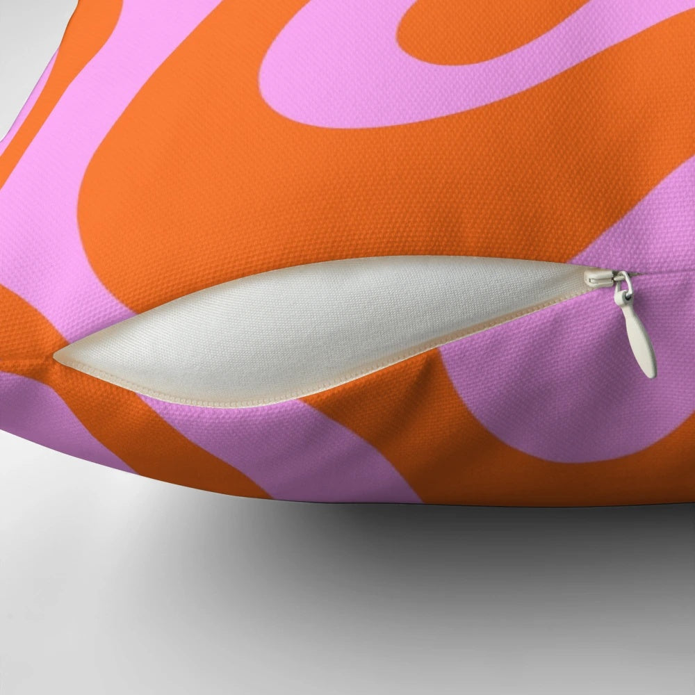 Retro-inspired abstract pattern pillow in hot pink and red-orange with a vibrant swirling design.
