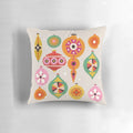 Closeup of a vintage-inspired Christmas tree ornament pillow with bright, colorful baubles and a retro design.