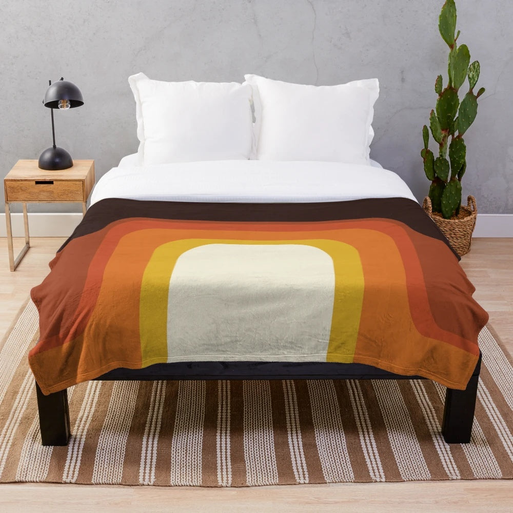 Midcentury modern plush blanket with a vibrant orange and rainbow geometric pattern