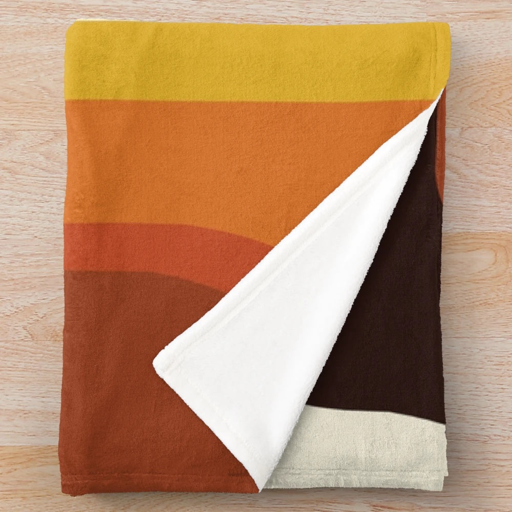 Midcentury modern plush blanket with a vibrant orange and rainbow geometric pattern