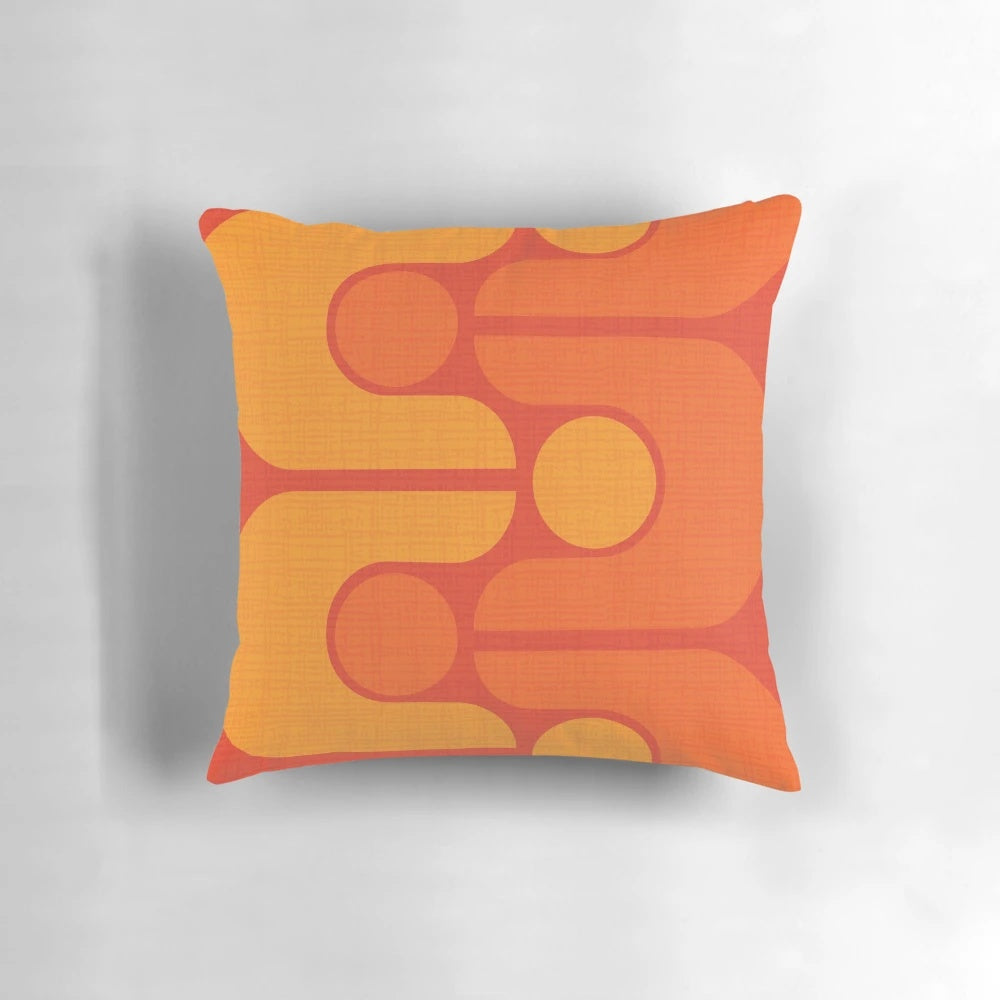 Vintage-inspired orange and yellow patterned pillow with a mid-century modern design