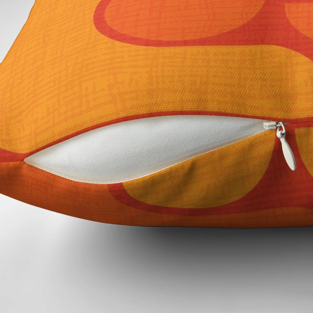 Vintage-inspired orange and yellow patterned pillow with a mid-century modern design