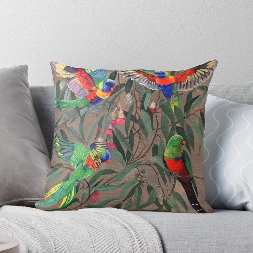 Colorful rosella parrots perched on a branch, featured on a decorative throw pillow.