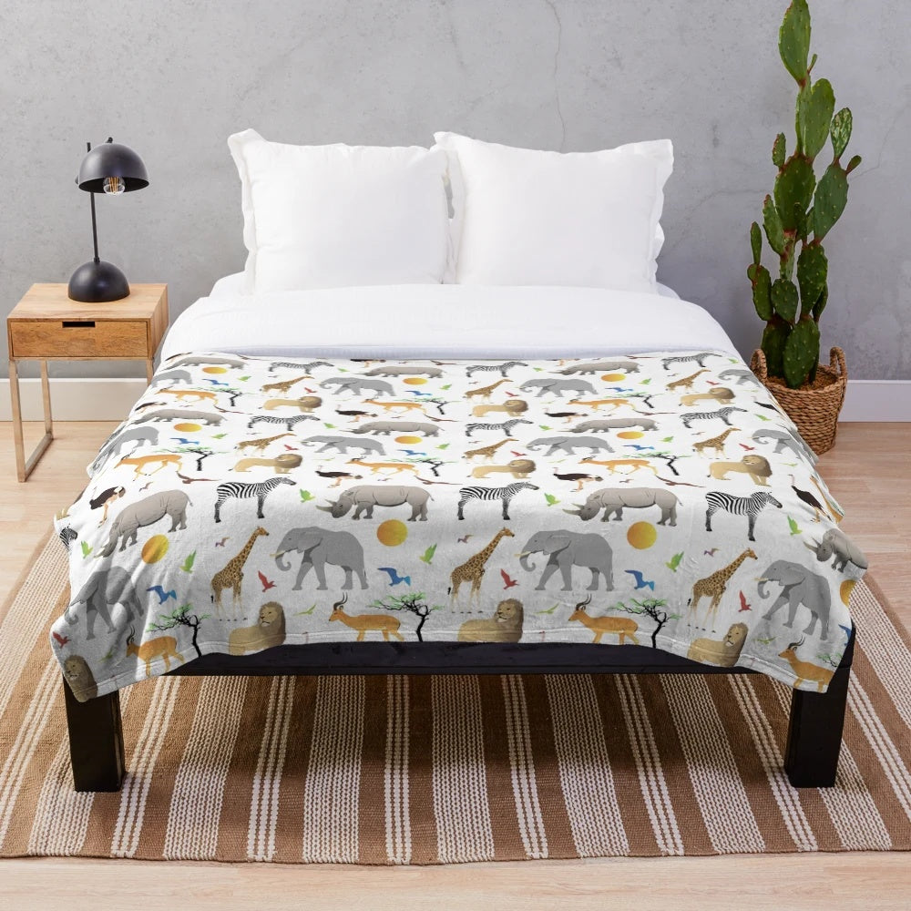 Colorful plush blanket with various African safari animals like elephants, zebras, and giraffes