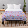 Sakura-inspired plush blanket with a violet pattern and anime-style design