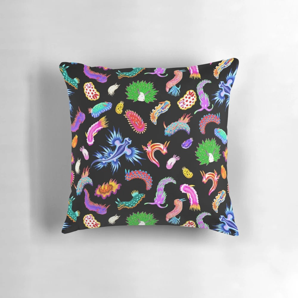 Colorful rainbow nudibranchs (sea slugs) printed on a throw pillow for vibrant marine-themed home decor.