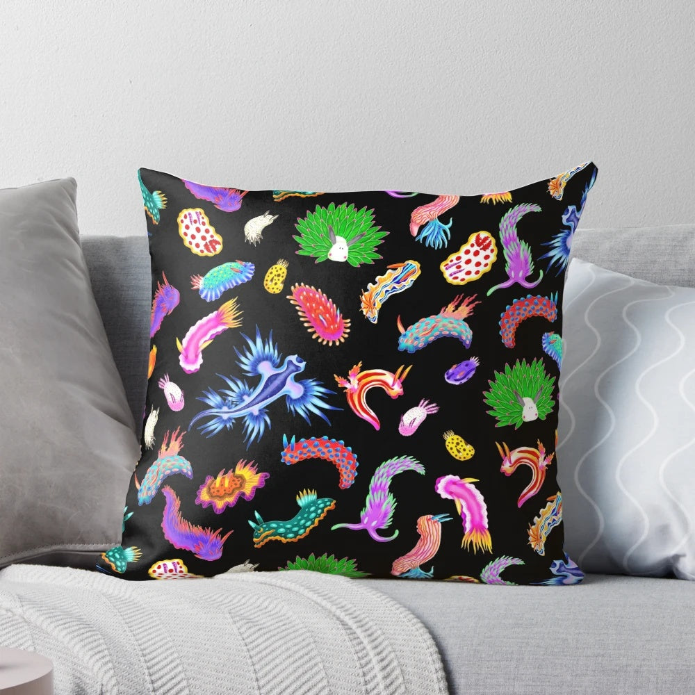 Colorful rainbow nudibranchs (sea slugs) printed on a throw pillow for vibrant marine-themed home decor.