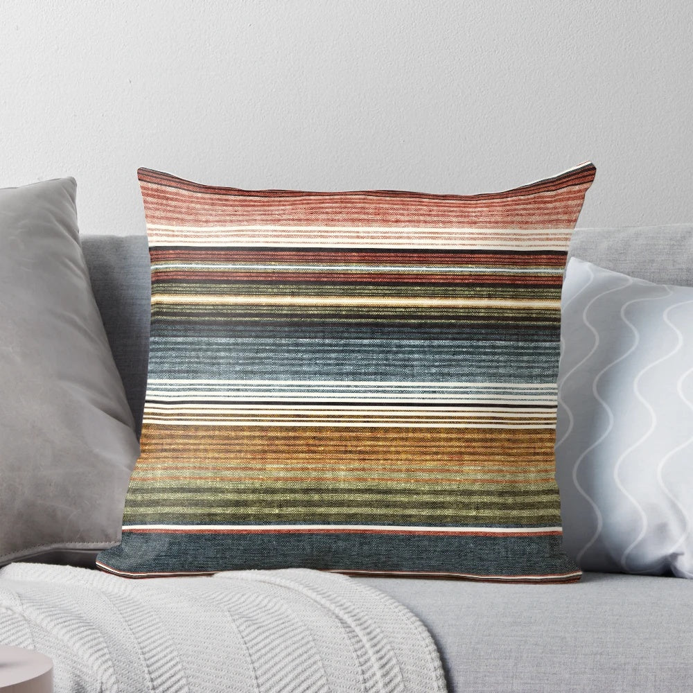 Decorative serape stripe pattern pillow in rust orange and blue colors
