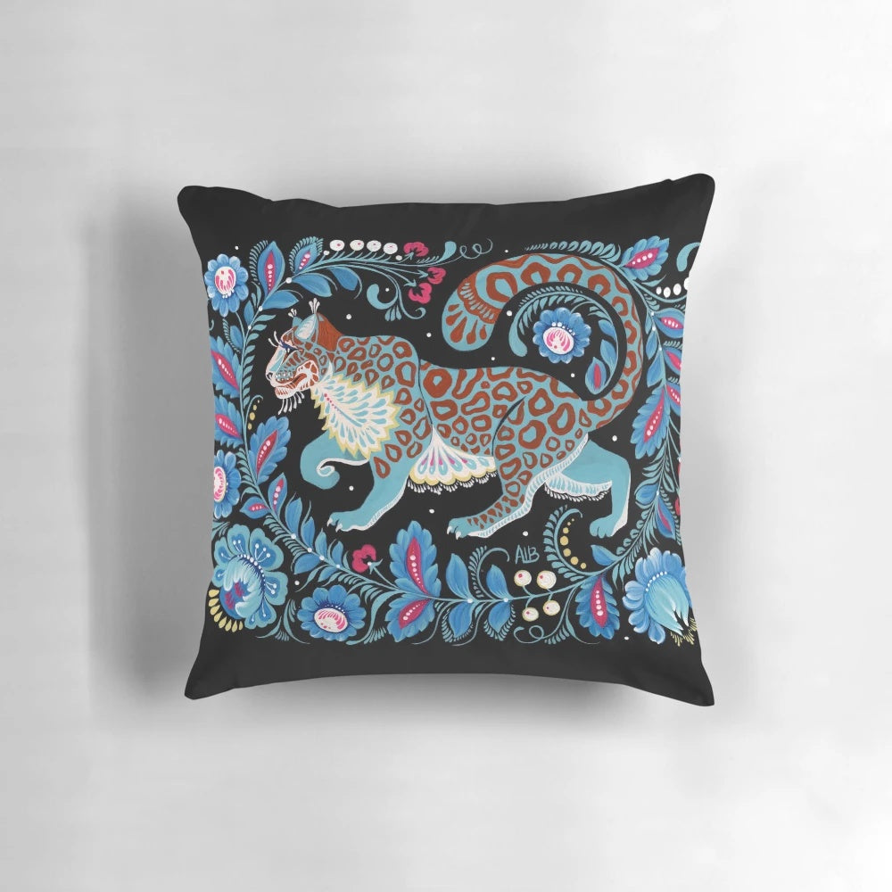 Vibrant hand-painted snow leopard folk art design on a decorative pillow
