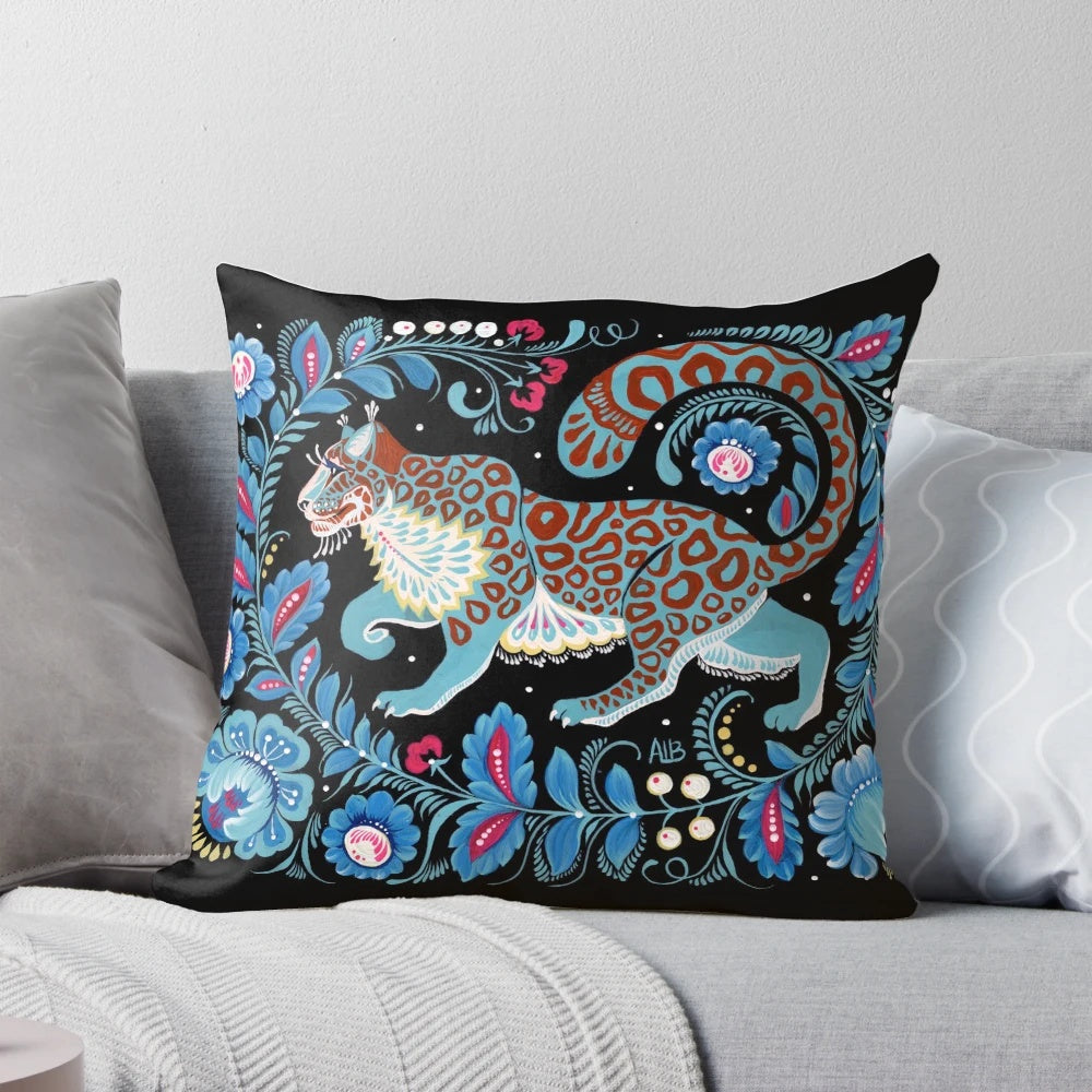 Vibrant hand-painted snow leopard folk art design on a decorative pillow