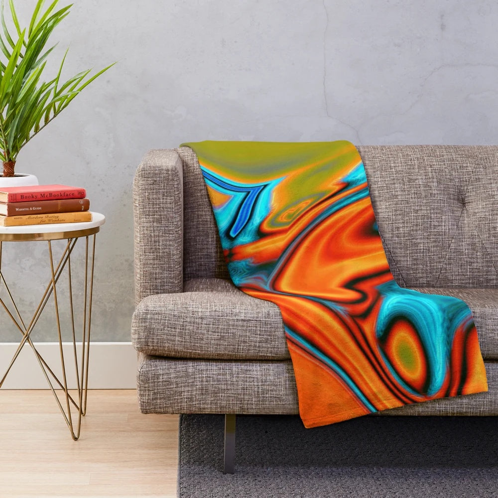 Plush blanket with vibrant turquoise and orange abstract swirl pattern