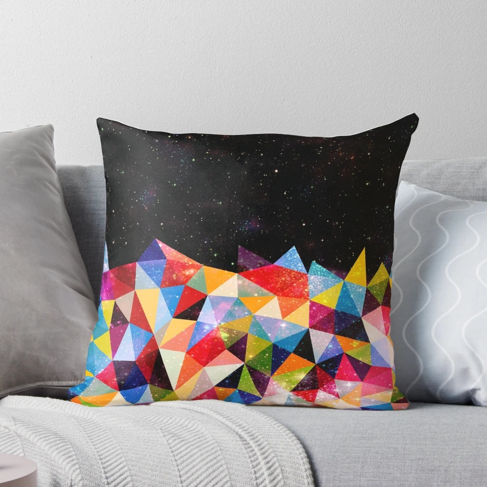 Colorful space-themed pillow with triangular, geometric patterns reminiscent of a nebula