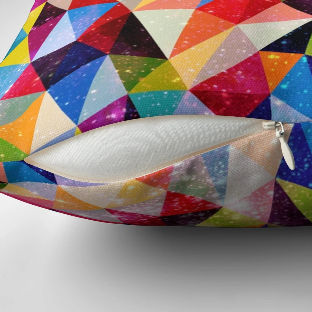 Colorful space-themed pillow with triangular, geometric patterns reminiscent of a nebula