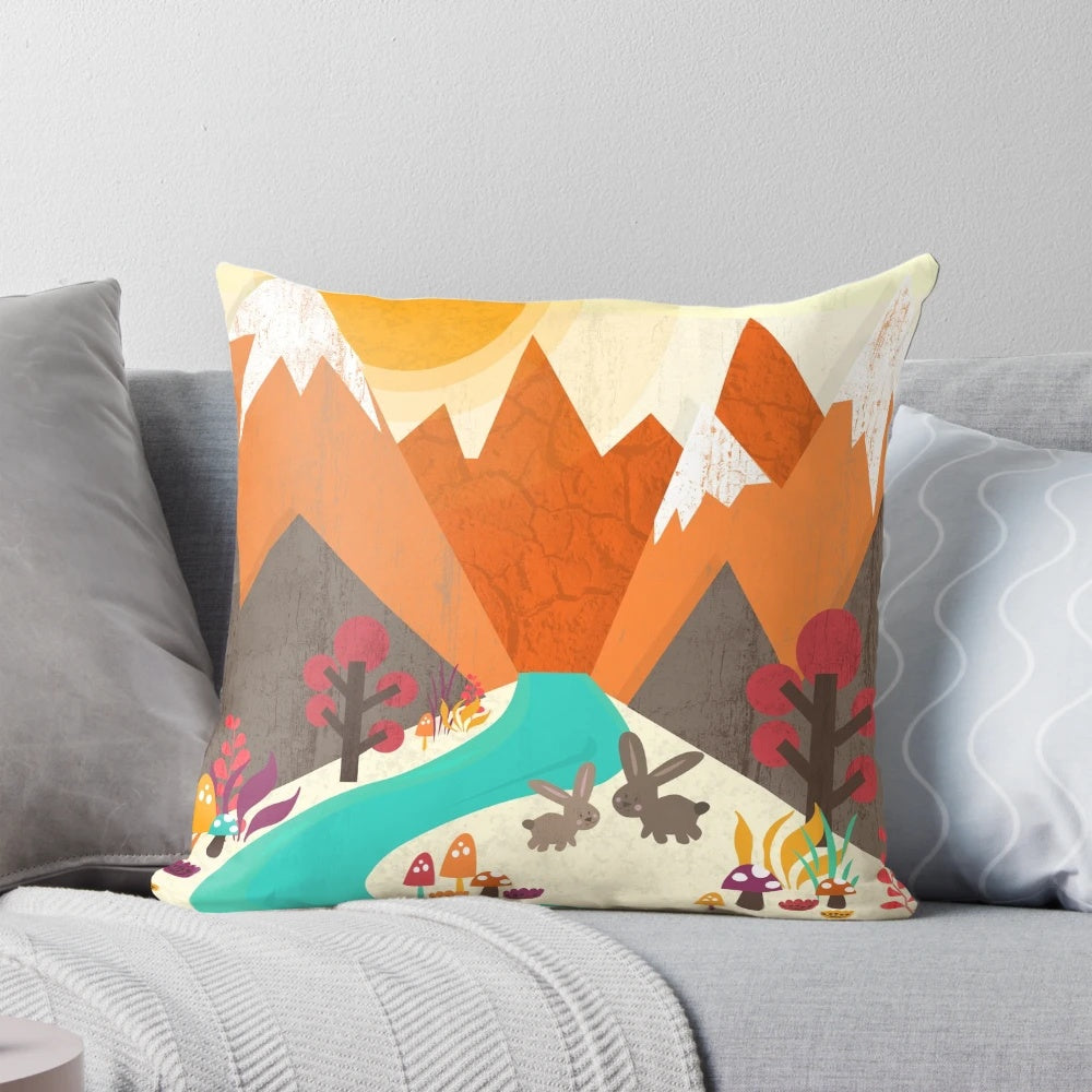 A colorful spring-themed pillow featuring a pastoral landscape with a rabbit, flowers, and a mountain in the background.