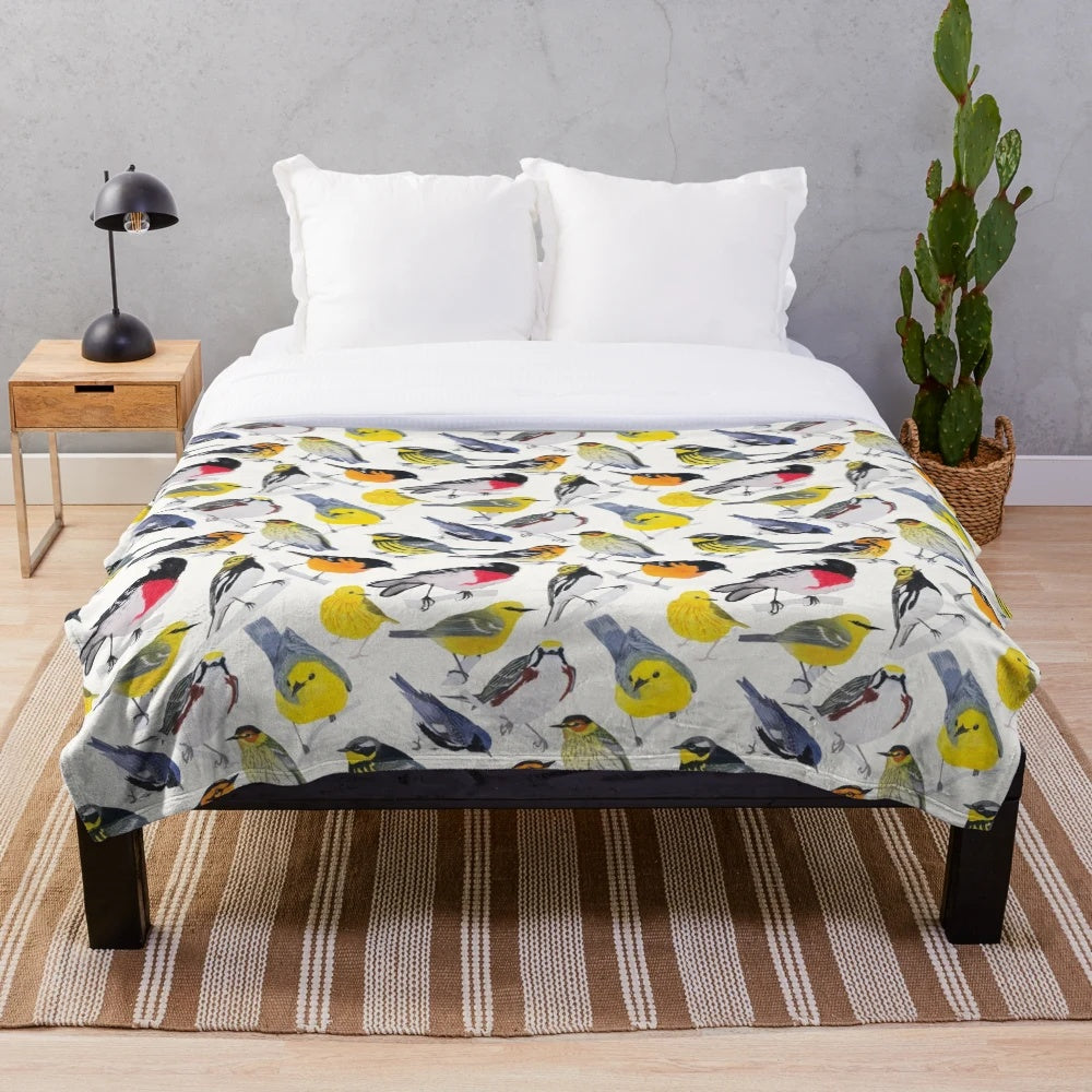 Colorful plush blanket featuring a vibrant watercolor design of birds and flowers