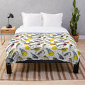 Colorful plush blanket featuring a vibrant watercolor design of birds and flowers