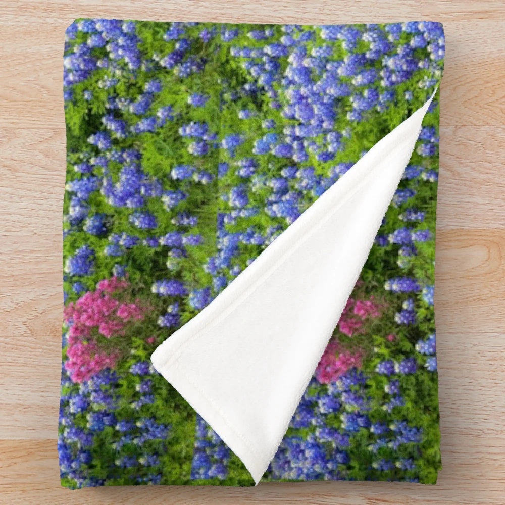 Plush blanket featuring vibrant springtime wildflowers like bluebonnets and prairie paintbrush