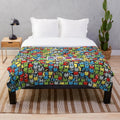 Stardew Valley inspired plush blanket with a colorful 8-bit junimo design