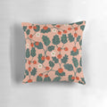 Closeup of a vibrant watercolor painting of strawberry blossoms on a decorative pillow