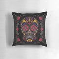 A dark, colorful sugar skull design pillow with floral and symmetrical patterns.