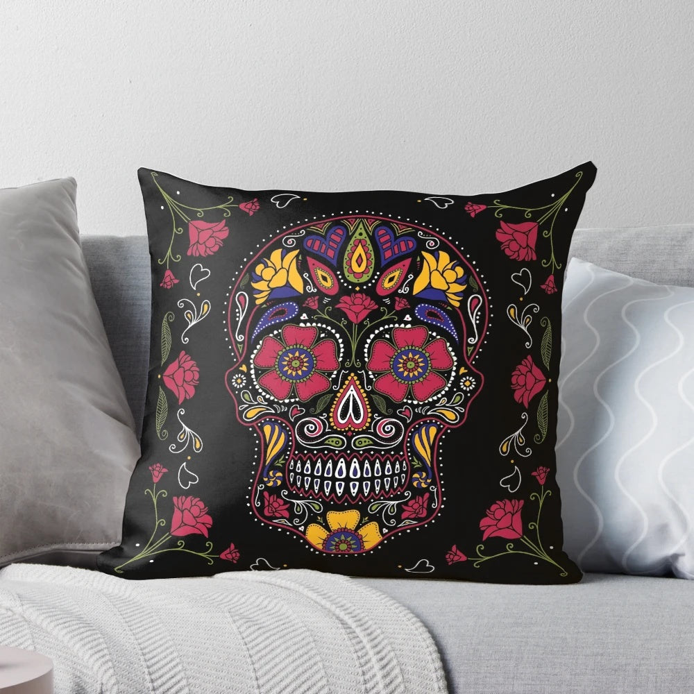 A dark, colorful sugar skull design pillow with floral and symmetrical patterns.