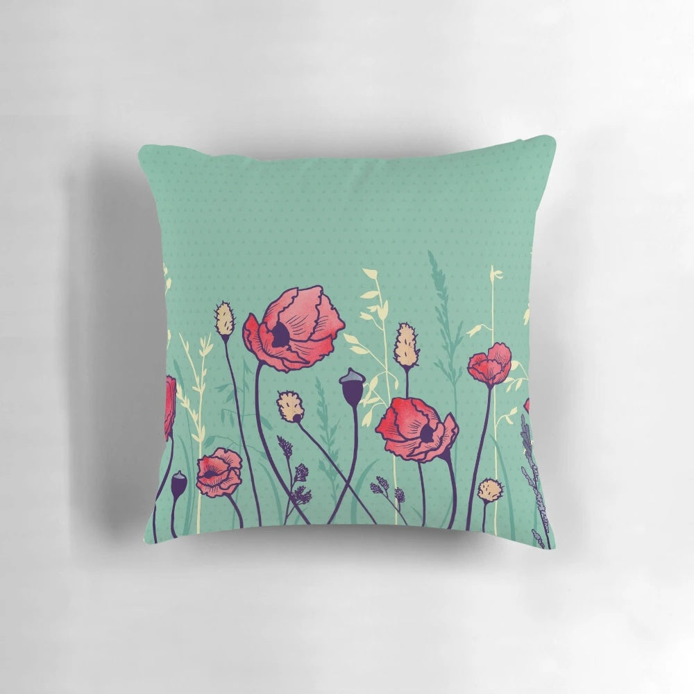A watercolor-style throw pillow featuring a vibrant field of poppies and geometric shapes in shades of green, yellow, and red.
