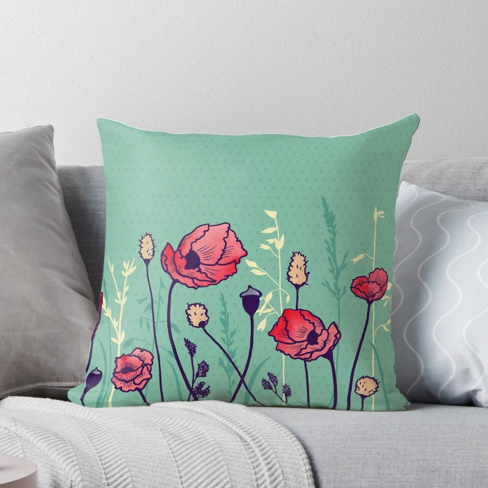 A watercolor-style throw pillow featuring a vibrant field of poppies and geometric shapes in shades of green, yellow, and red.
