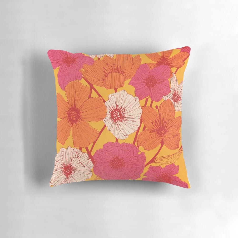 Colorful retro-style floral pattern decorative throw pillow in pink, yellow, and orange